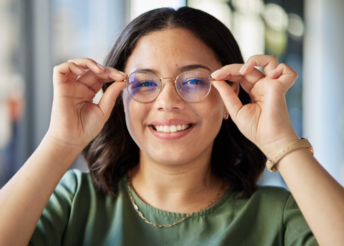 Woman, glasses and portrait with smile, optometry and health with eyes, choice and fashion in store.